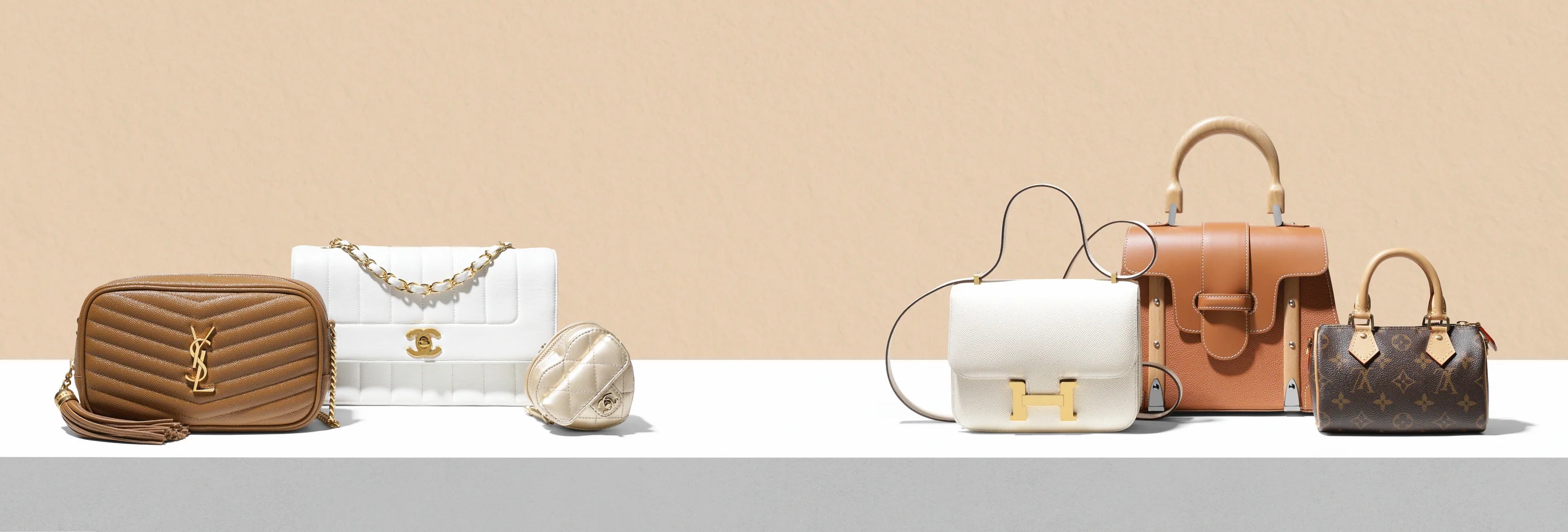 Collection of various handbags on a light beige background